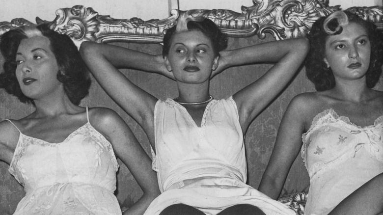 Sophia Loren sitting and looking away with other women