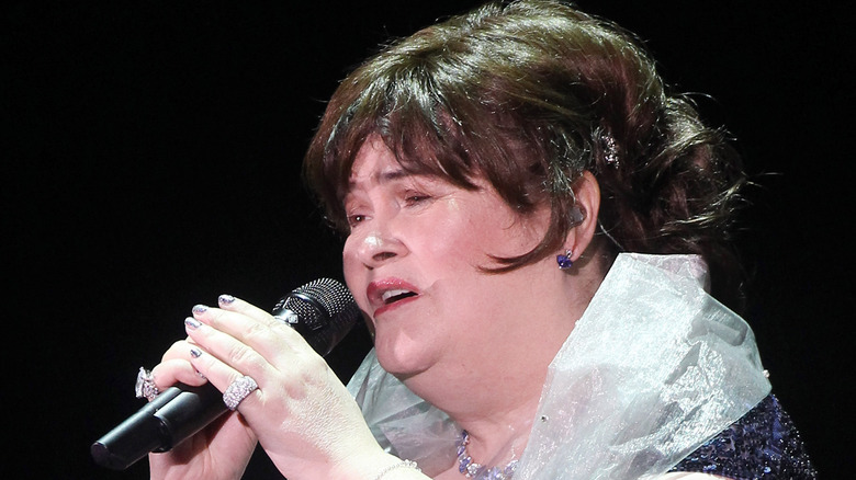 Susan Boyle singing and holding microphone