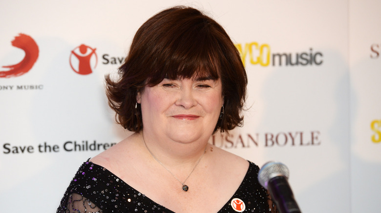 Susan Boyle smiling in front of microphone