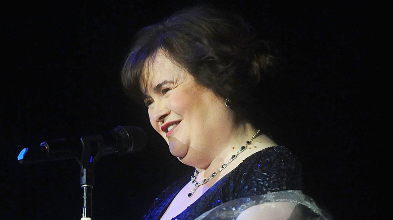 Susan Boyle smiling in front of microphone