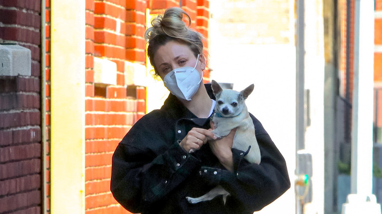 Kaley Cuoco in a mask with dog