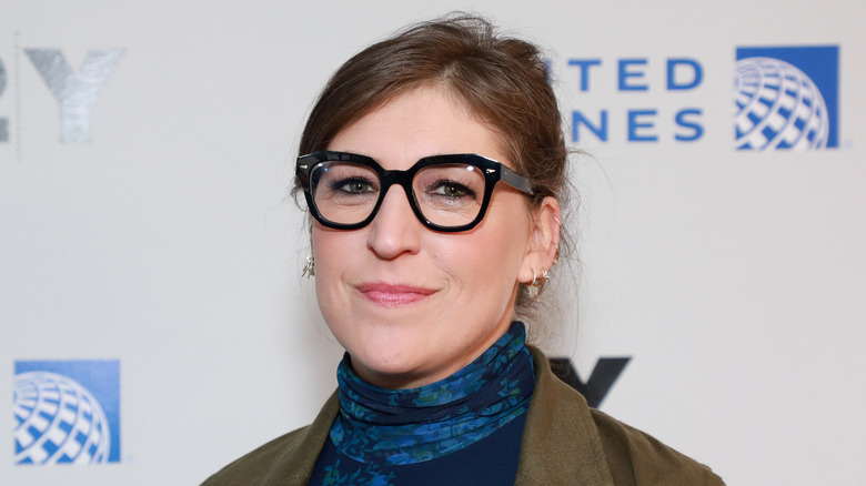 Mayim Bialik posing for photos in black glasses