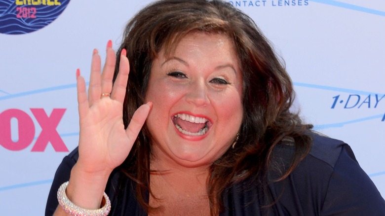 Abby Lee Miller waving and smiling