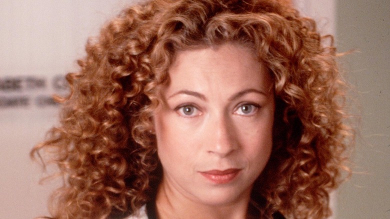 Alex Kingston posing in a feathered dress 