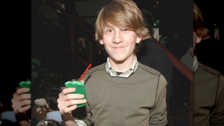 Erik Per Sullivan as a kid holding a green drink