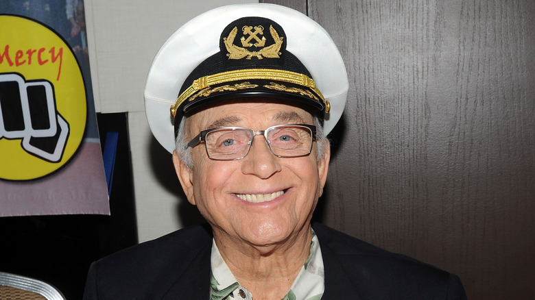 Gavin MacLeod smiling in captain's hat