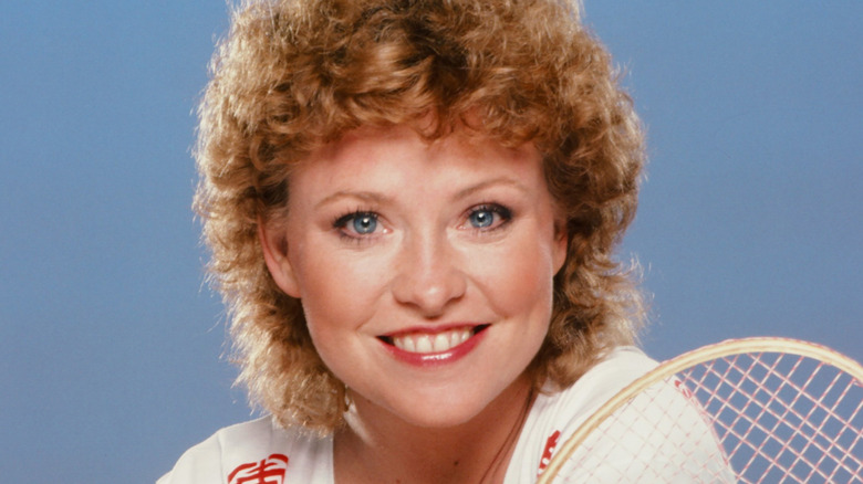 Lauren Tewes smiling while holding racket