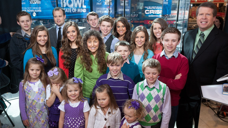 The Duggar family posing together on a trip