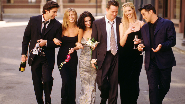 The cast of Friends walks arm in arm