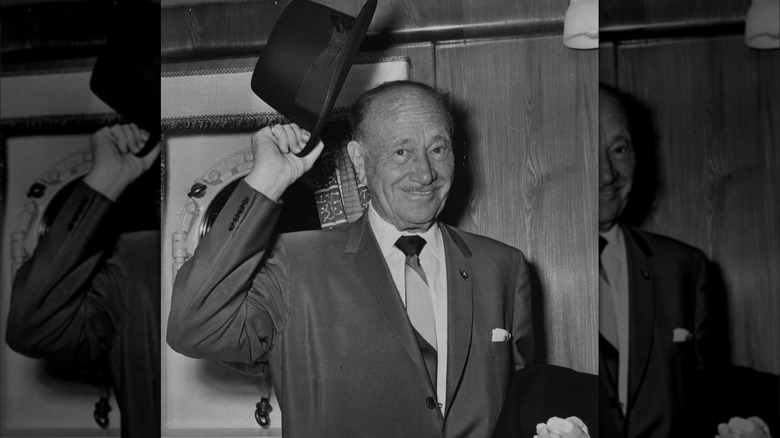 Conrad Hilton lifting his hat