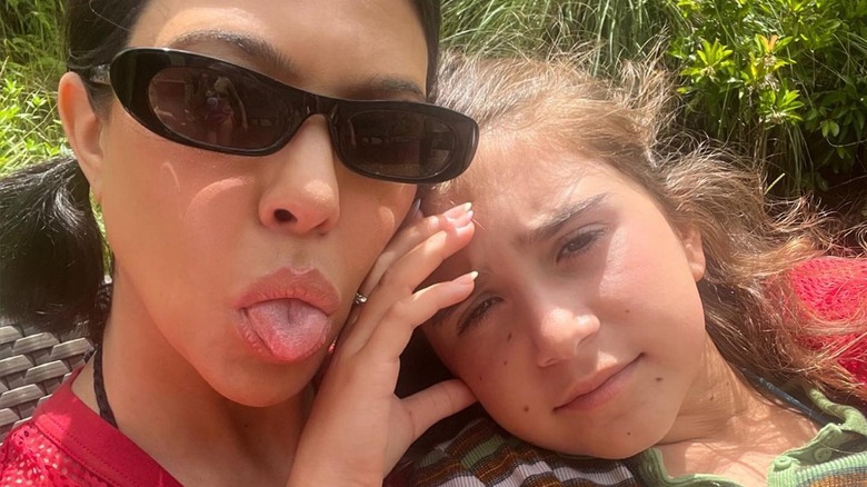 Kourtney Kardashian posing with her daughter Penelope Disick