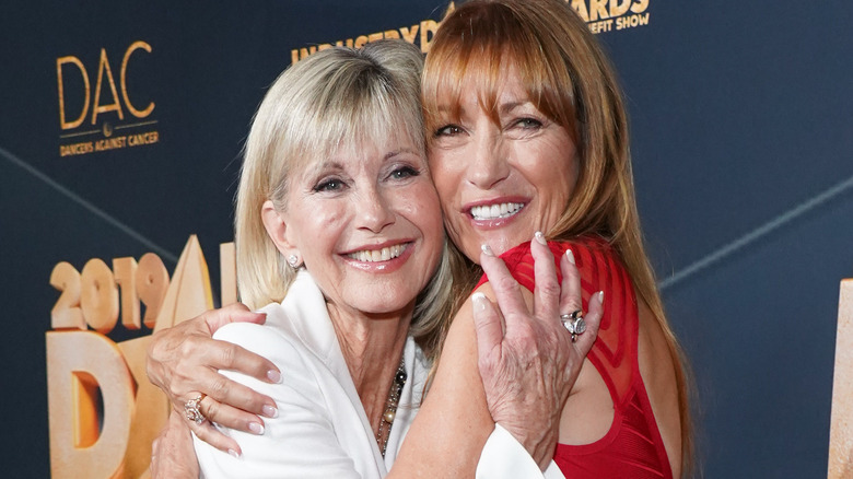 Olivia Newton-John and Jane Seymour embracing