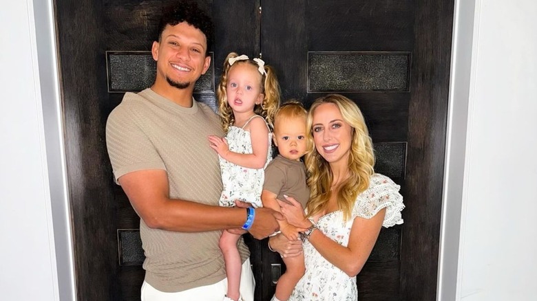 patrick and brittany mahomes posing with kids sterling and bronze