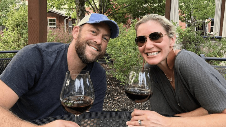 Dave and Jenny Marrs smiling with wine