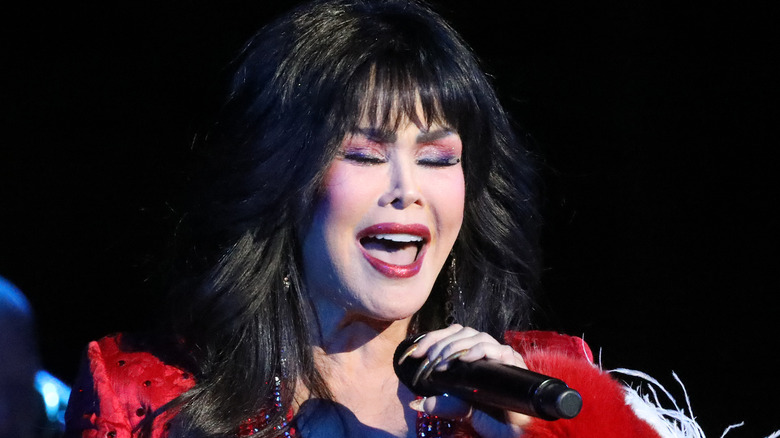 Marie Osmond singing into microphone