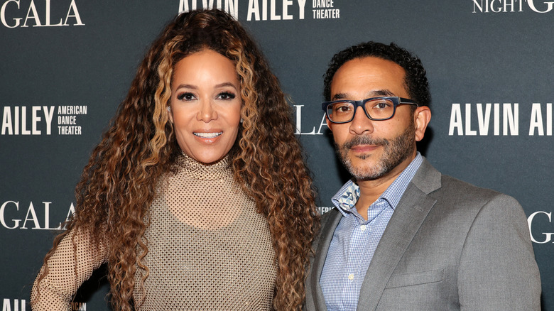 Sunny Hostin and Emmanuel Hostin posing for photos