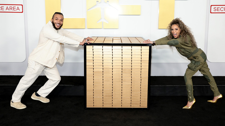 Sunny Hostin and Gabe Hostin pushing a box