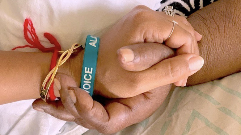 Tamera Mowry-Housley holds her grandmother's hand