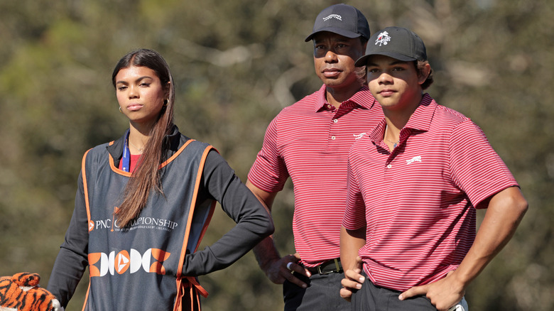 Sam, Tiger, and Charlie Woods on golf course