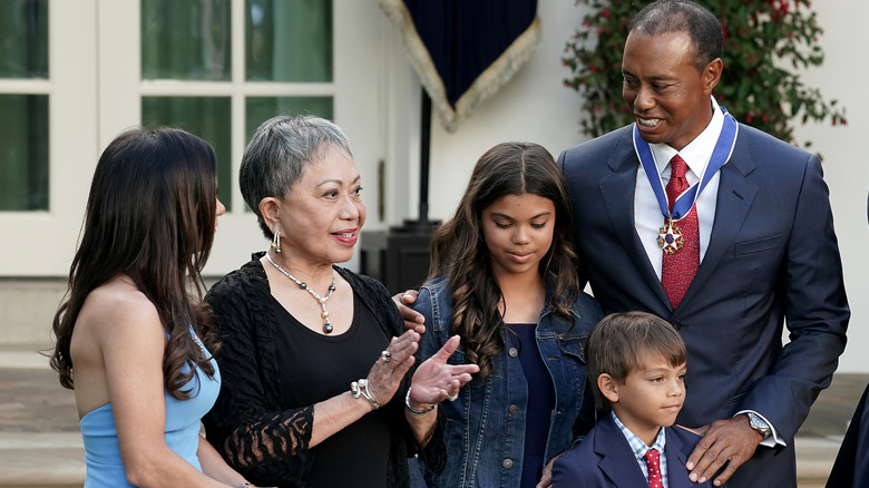 Kultida Woods with Sam, Charlie, and Tiger Woods being awarded