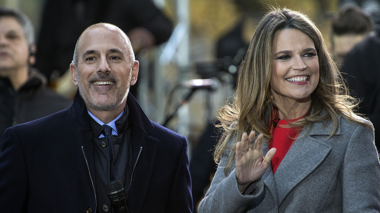 Matt Lauer and Savannah Guthrie waving outside