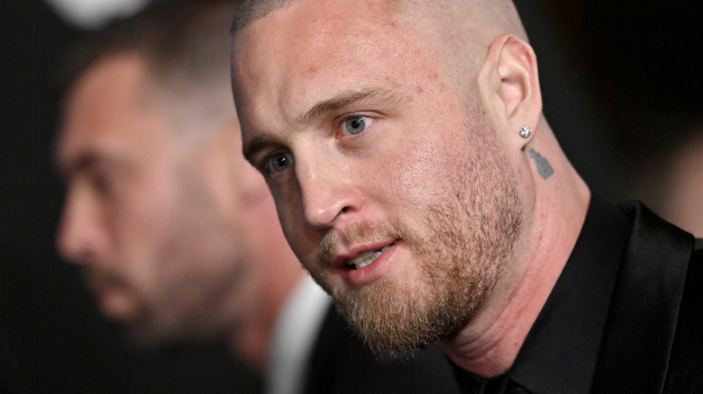 Close up of Chet Hanks in black shirt with diamond earring