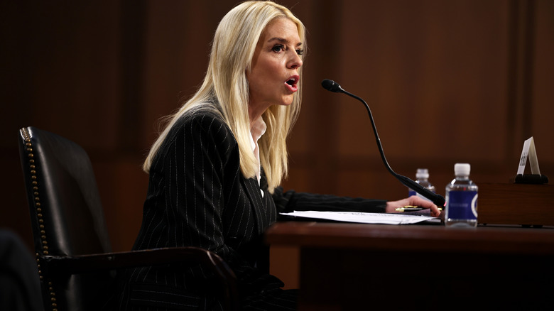 Pam Bondi speaking into a microphone