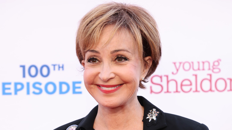 Annie Potts smiling in front of white backdrop