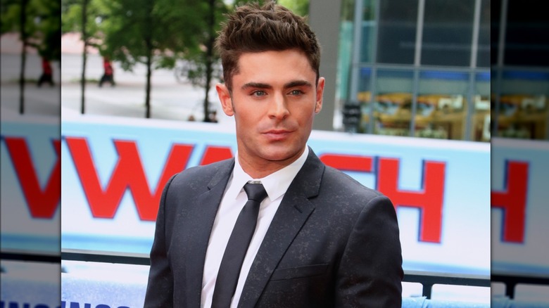 Zac Efron posing in suit