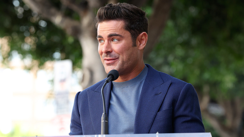 Zac Efron speaking in microphone