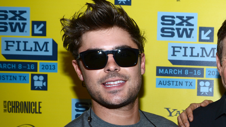 Zac Efron smiling in sunglasses