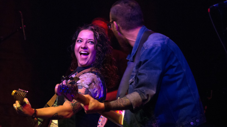 Ashley McBryde playing guitar with her band