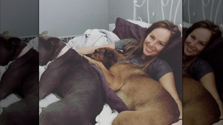 Mina Starsiak Hawk cuddling her dogs 