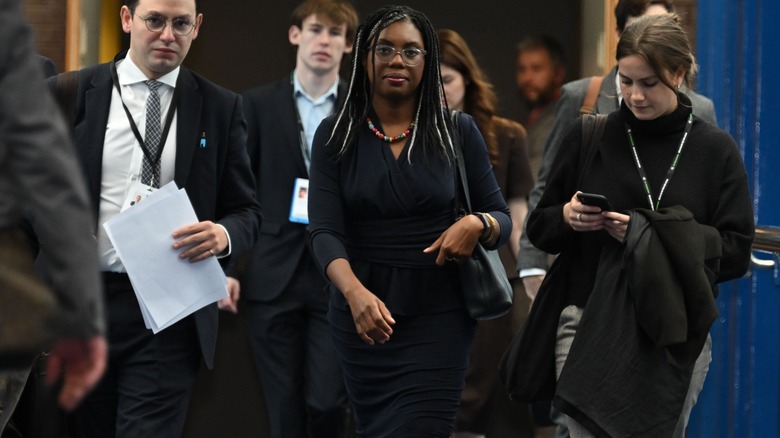 Kemi Badenoch walking with aides at the Conservative Party Conference