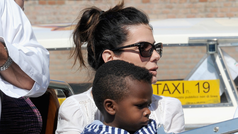 Sandra Bullock holding her son