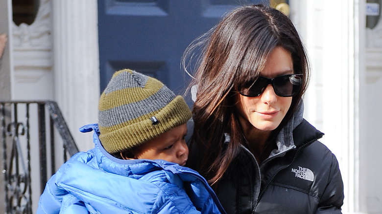 Sandra Bullock holding her son