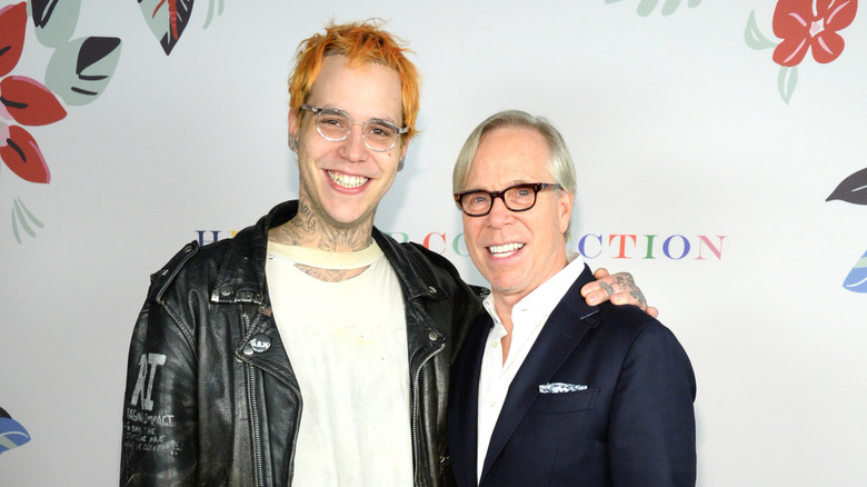 Tommy Hilfiger and Richard Hilfiger posing at an event