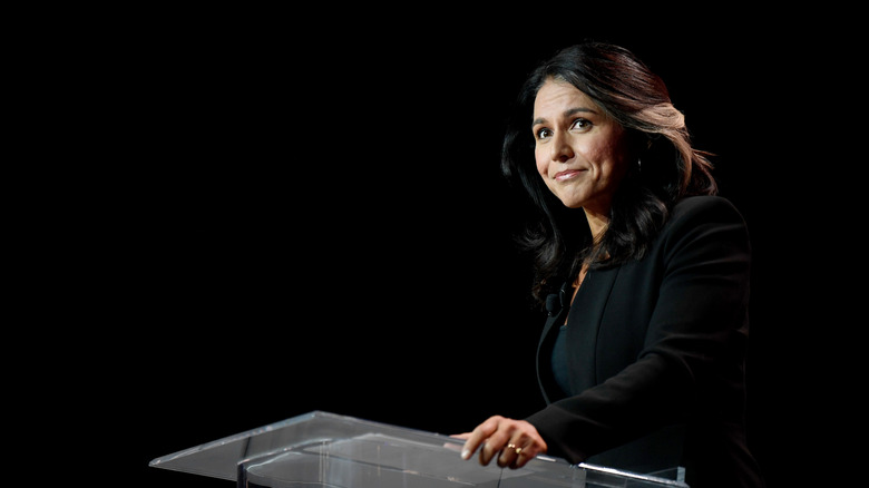 Tulsi Gabbard smiling at a podium