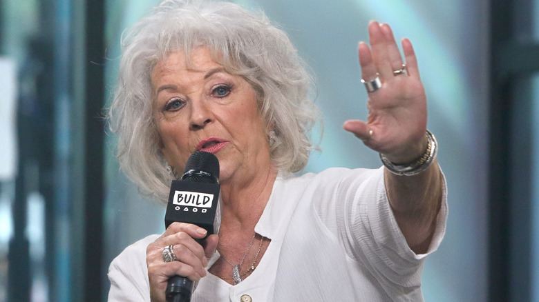 Paula Deen speaking with hand up