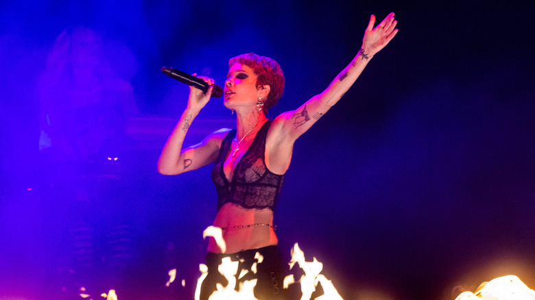 Halsey singing at a concert