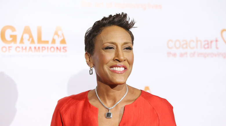 Robin Roberts smiling at an event in a red shirt