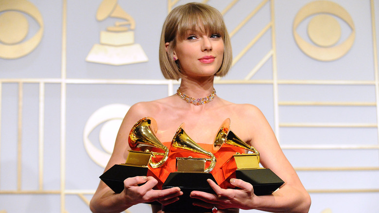 Taylor Swift holding Grammys