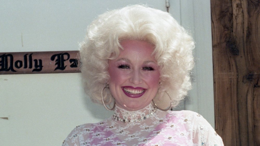 Dolly Parton in the '80s in front of a door