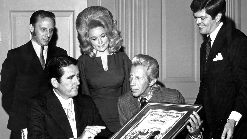 Dolly Parton and several men with Porter Wagoner