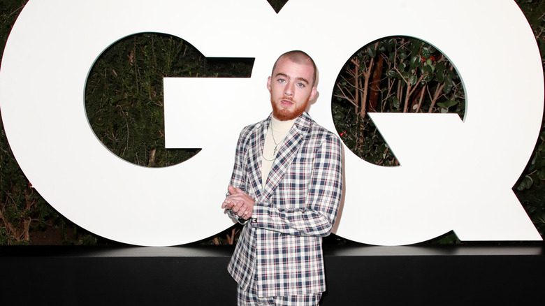 Angus Cloud posing in front of GQ sign