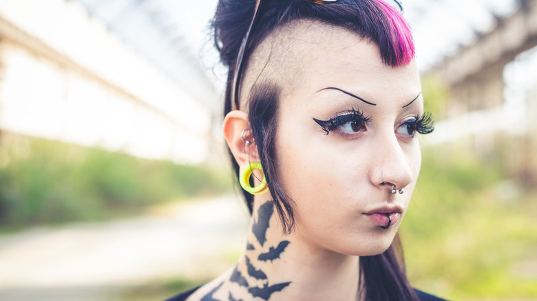 a woman with tattoos and piercings