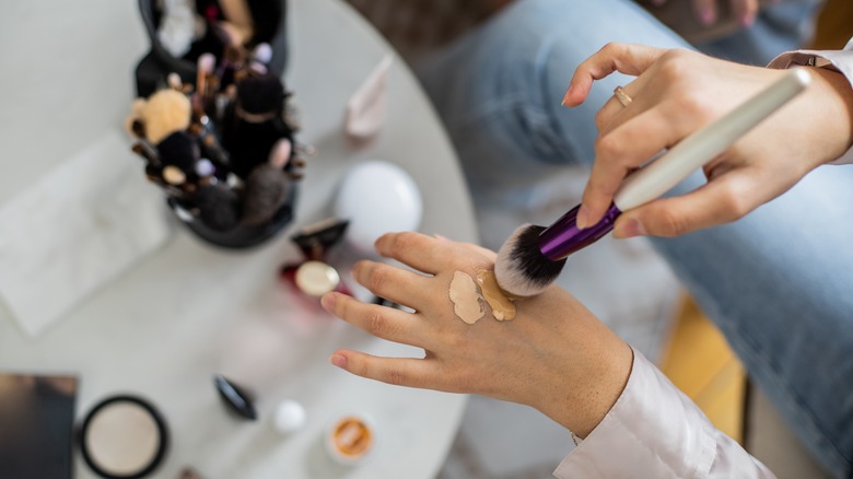 Woman applying transparent eyeliner