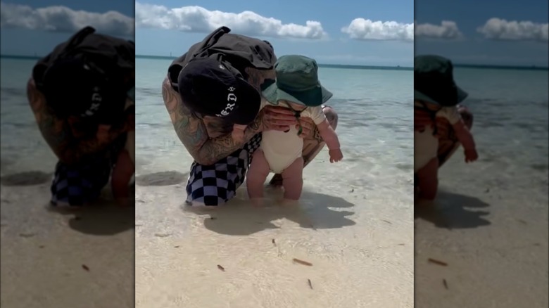 Travis Barker and Rocky Barker on a beach