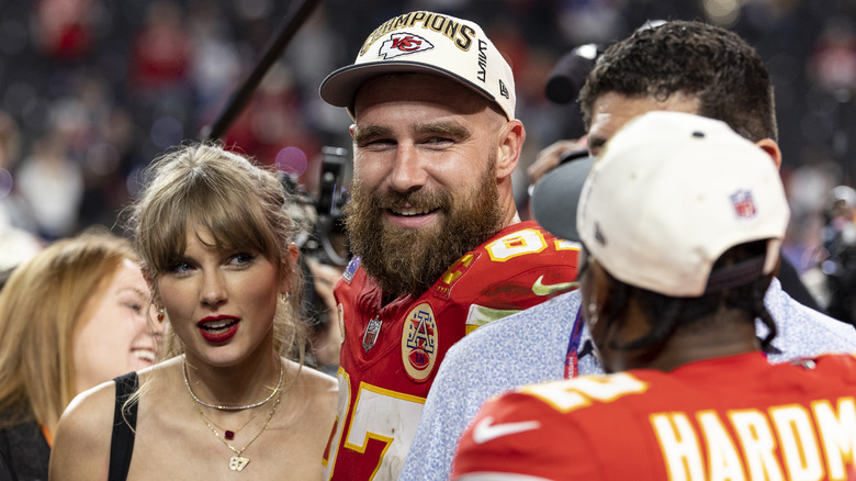 Taylor Swift and Travis Kelce smiling after a Superbowl win