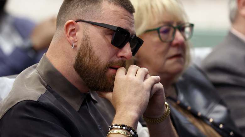 Travis Kelce and Donna Kelce listening to Jason Kelce's retirement speech